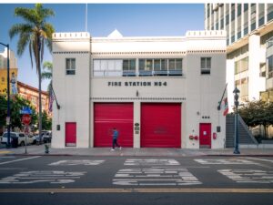 What exactly are fire station garage doors? A fire station with twin tall doors on a sunny day.