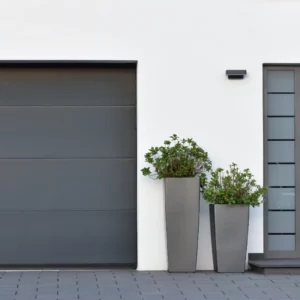 Top Garage Door Sales. Modern gray garage, next to the Scandinavian-style house