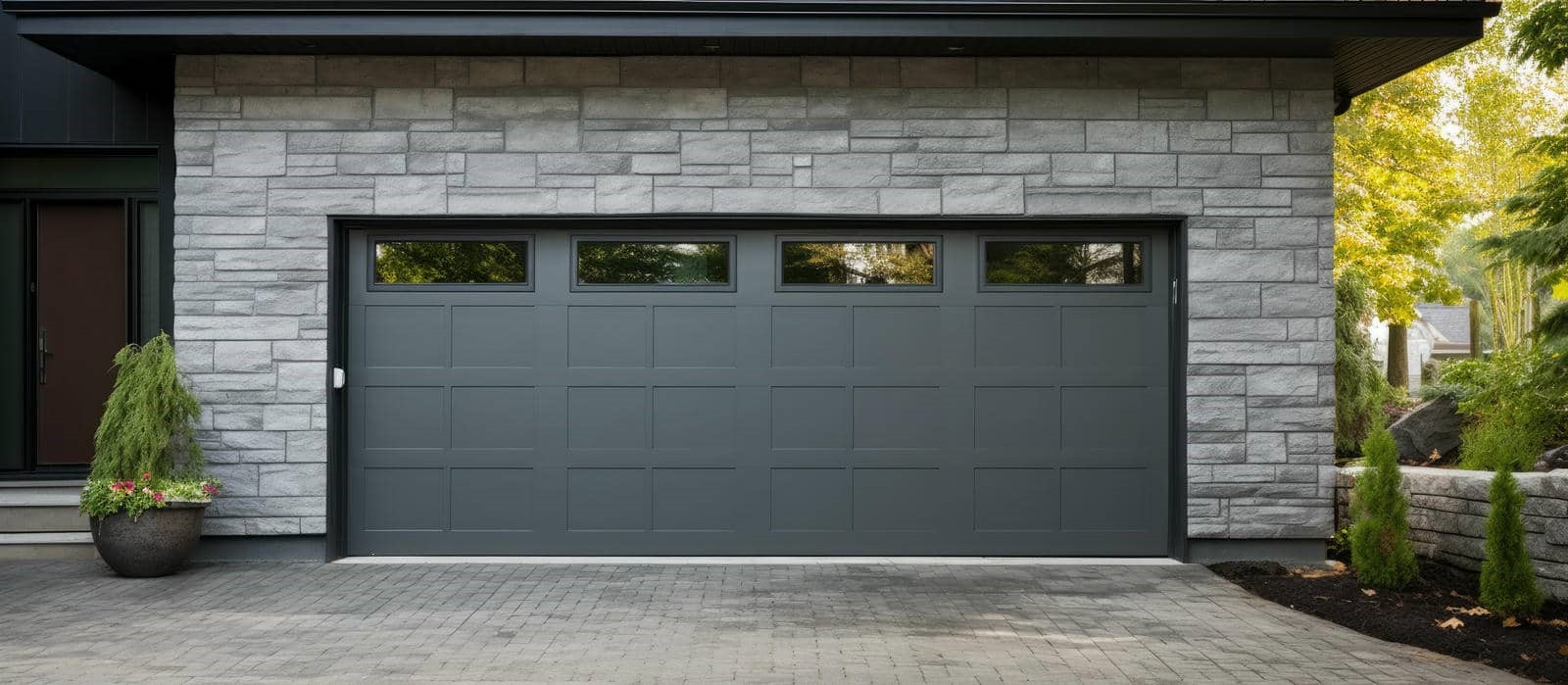 Modern garage door with stone facade.
