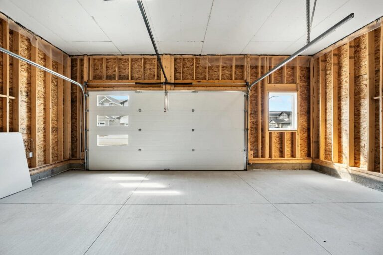 Empty garage with unfinished walls.