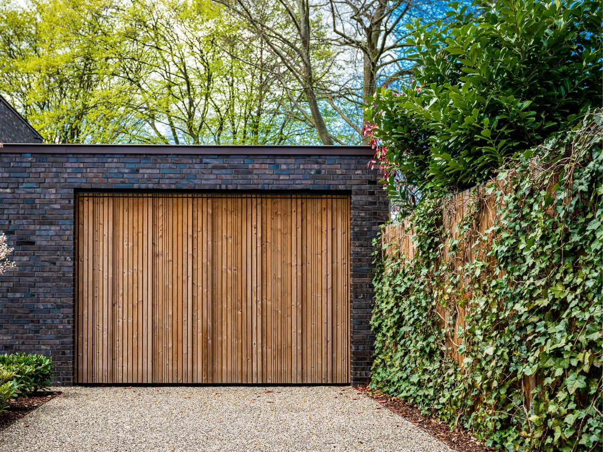 Modern garage door design ideas, like planked wood (shown) are par for the course in 2023.