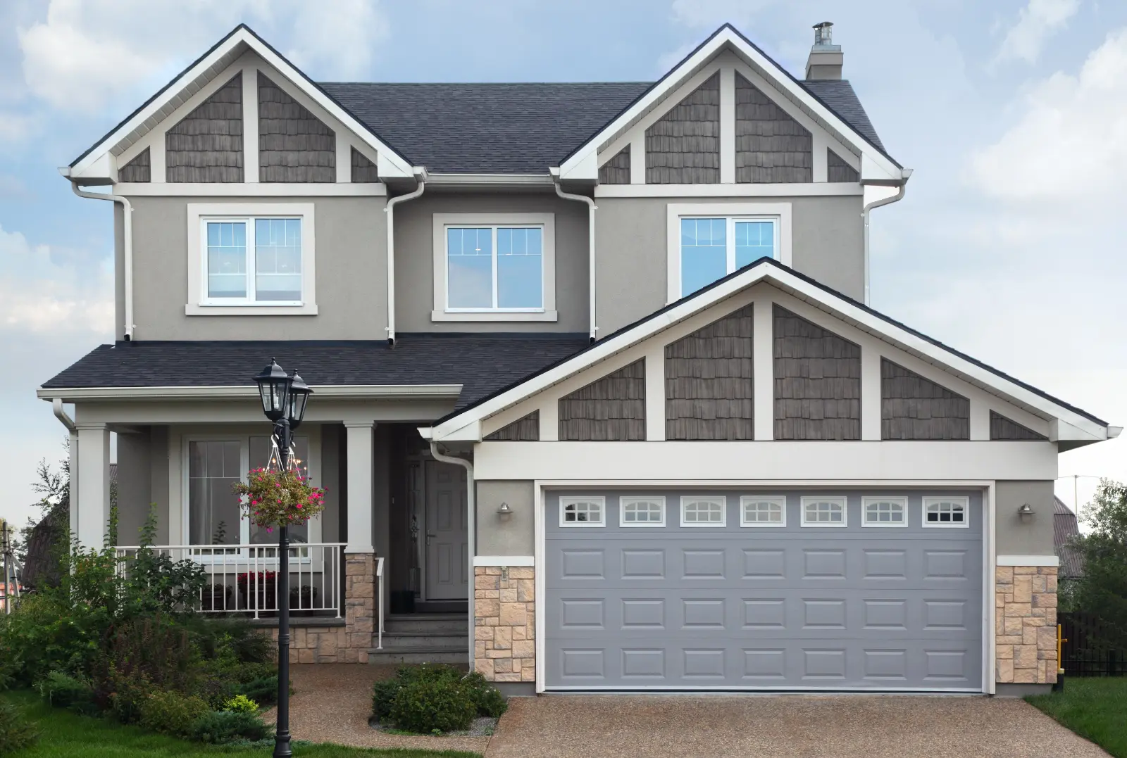 Affordable Garage Door Repair . New two-storied gray brick cottage with garage on first floor