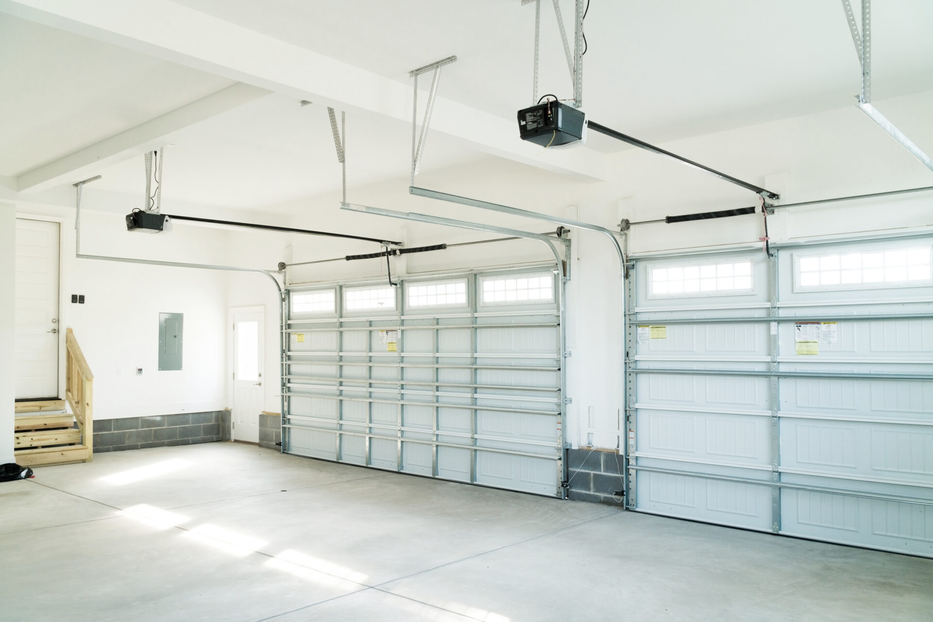 Garage Door Safety Features. Exterior of new home on bright sunny day with blue sky