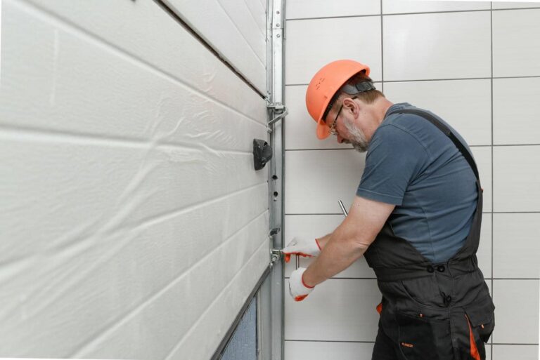 Person repairing a garage door mechanism.