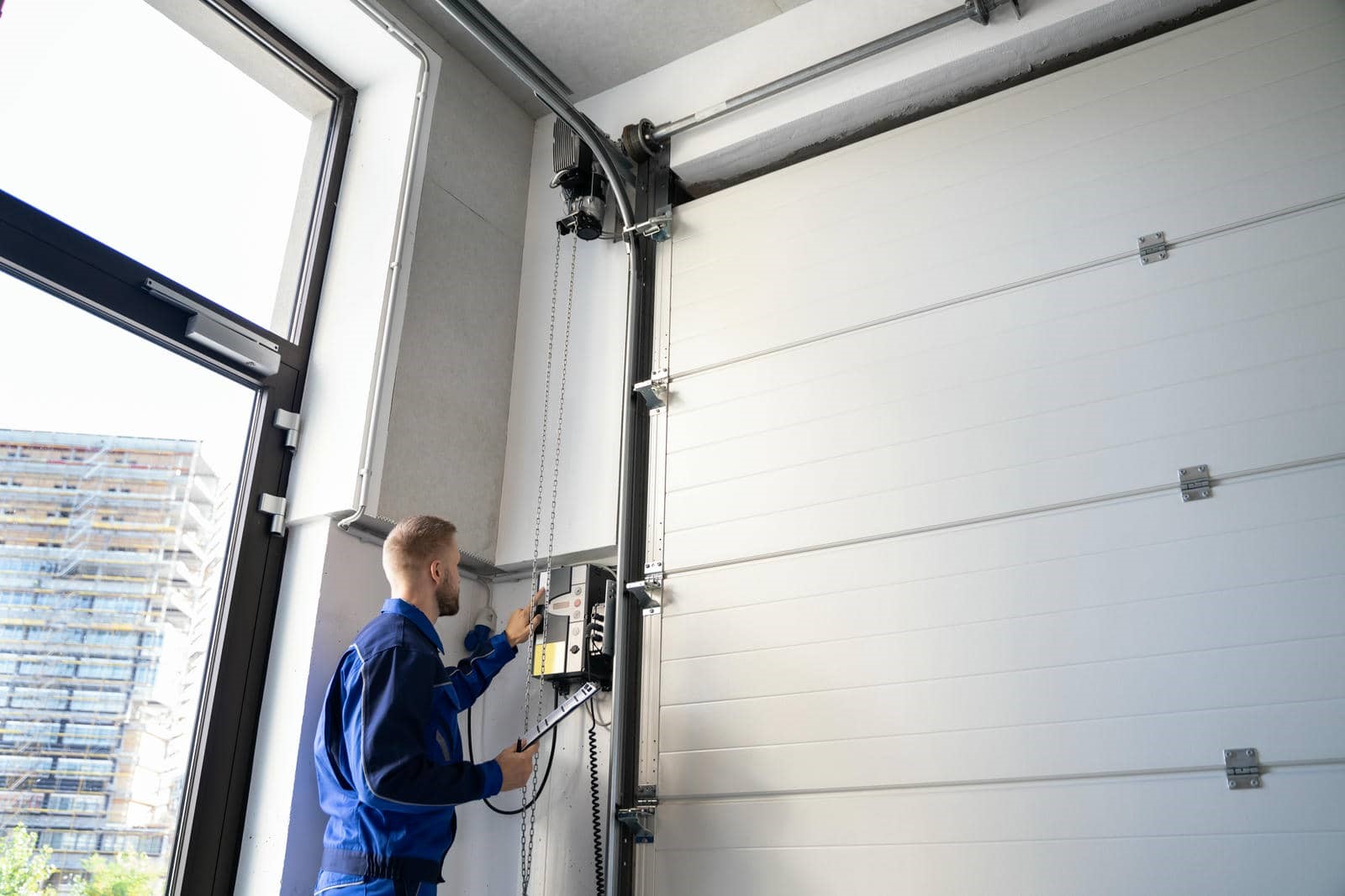 Person operating a garage door opener.