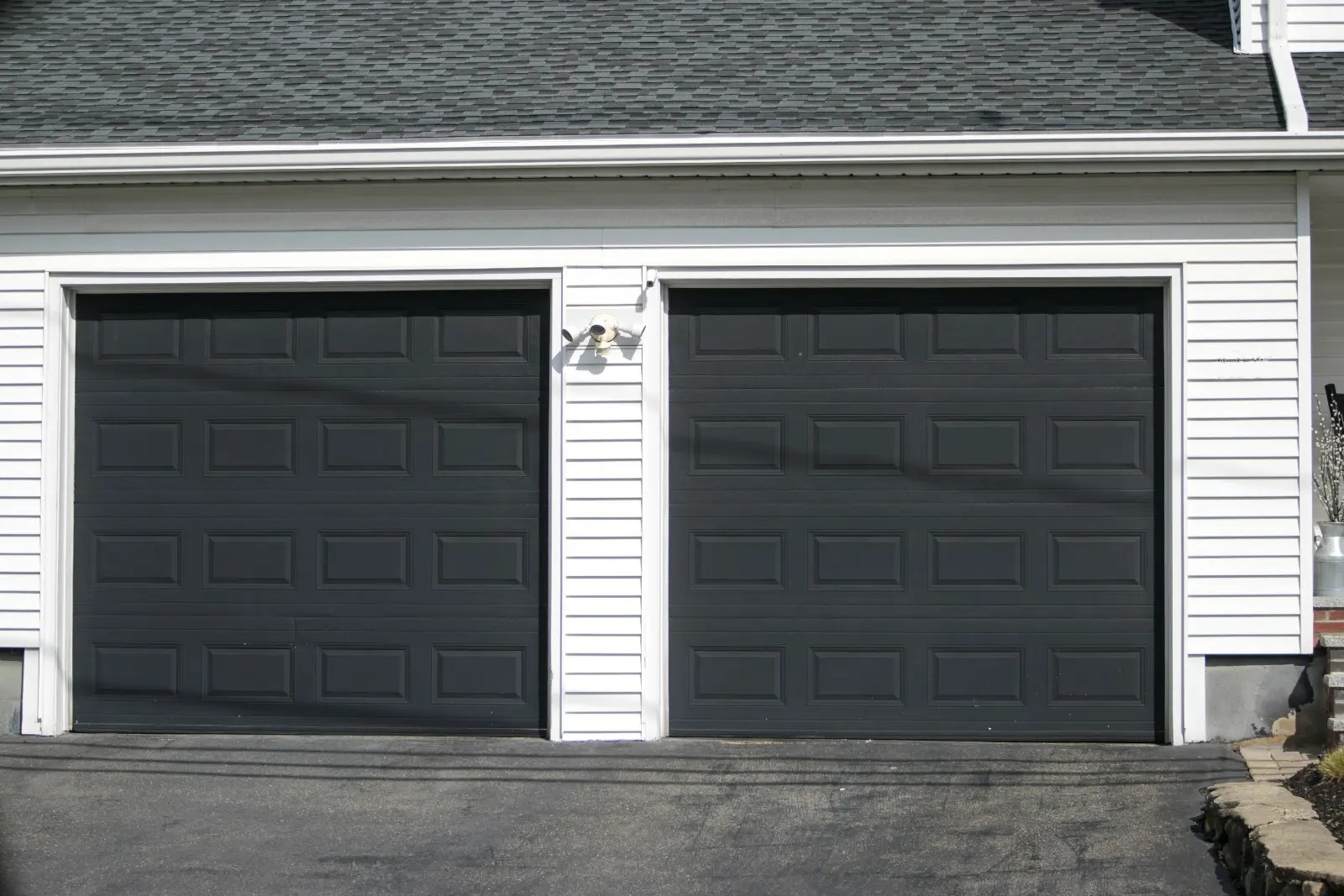 Safe Garage Door .Two cars Garage Door painted in black color in a typical single house