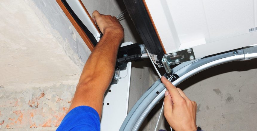 What happens when the garage door is noisy? You fix it! An Environmental Door technician repairs a loose garage door panel.