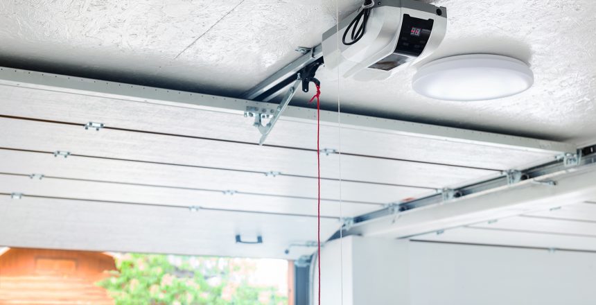 A new garage door opener with a red emergency string hanging down.