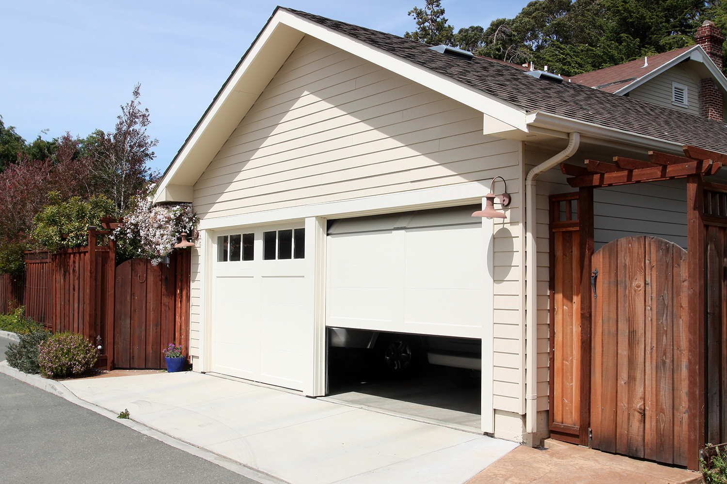 home with garage doors that has one door randomly opening