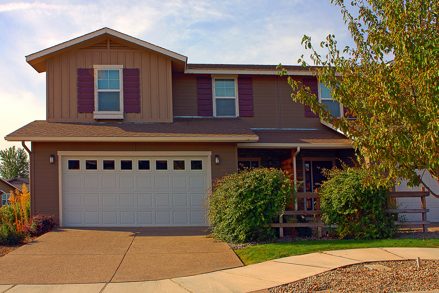 view of the outside of a home with a beautiful white garage door