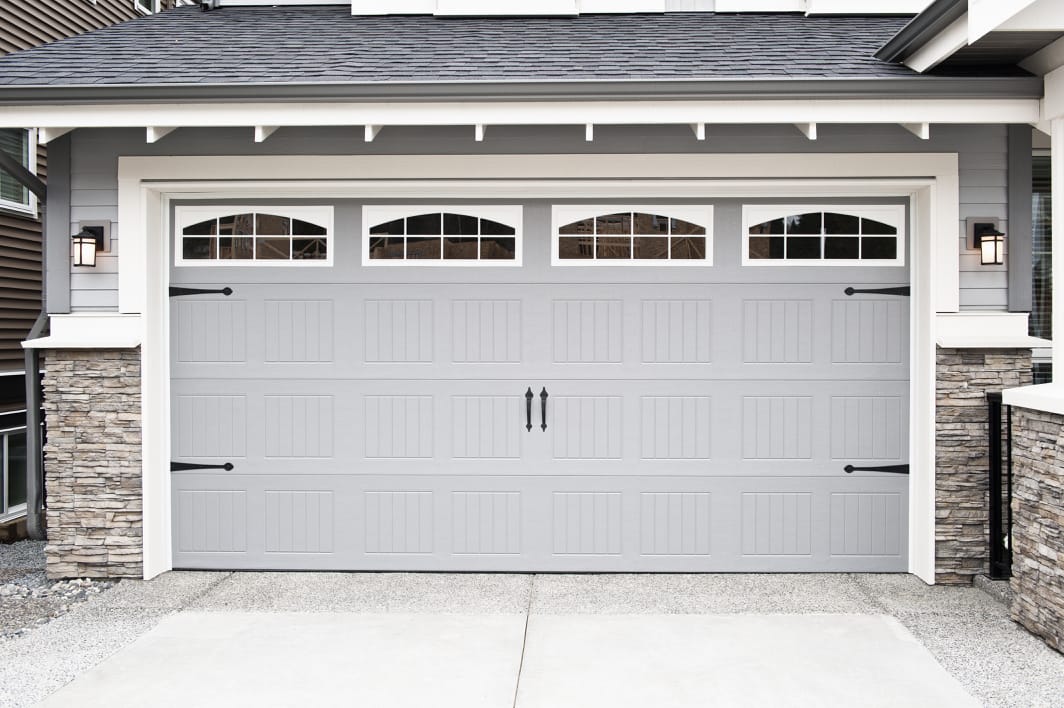 A muted gray garage door, one of the favorite garage door color ideas of 2022.
