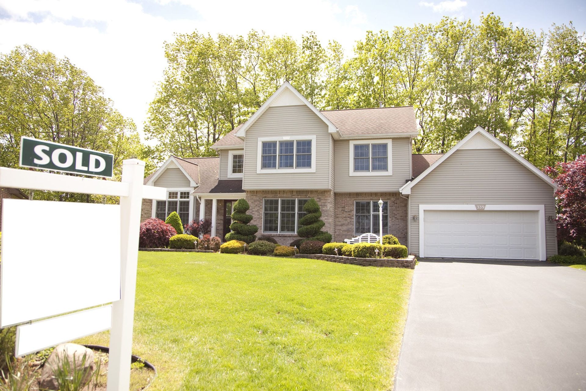 After buying a new house, consider a new garage door installation as your redesign kickoff. A newly sold house with an outdated garage door.