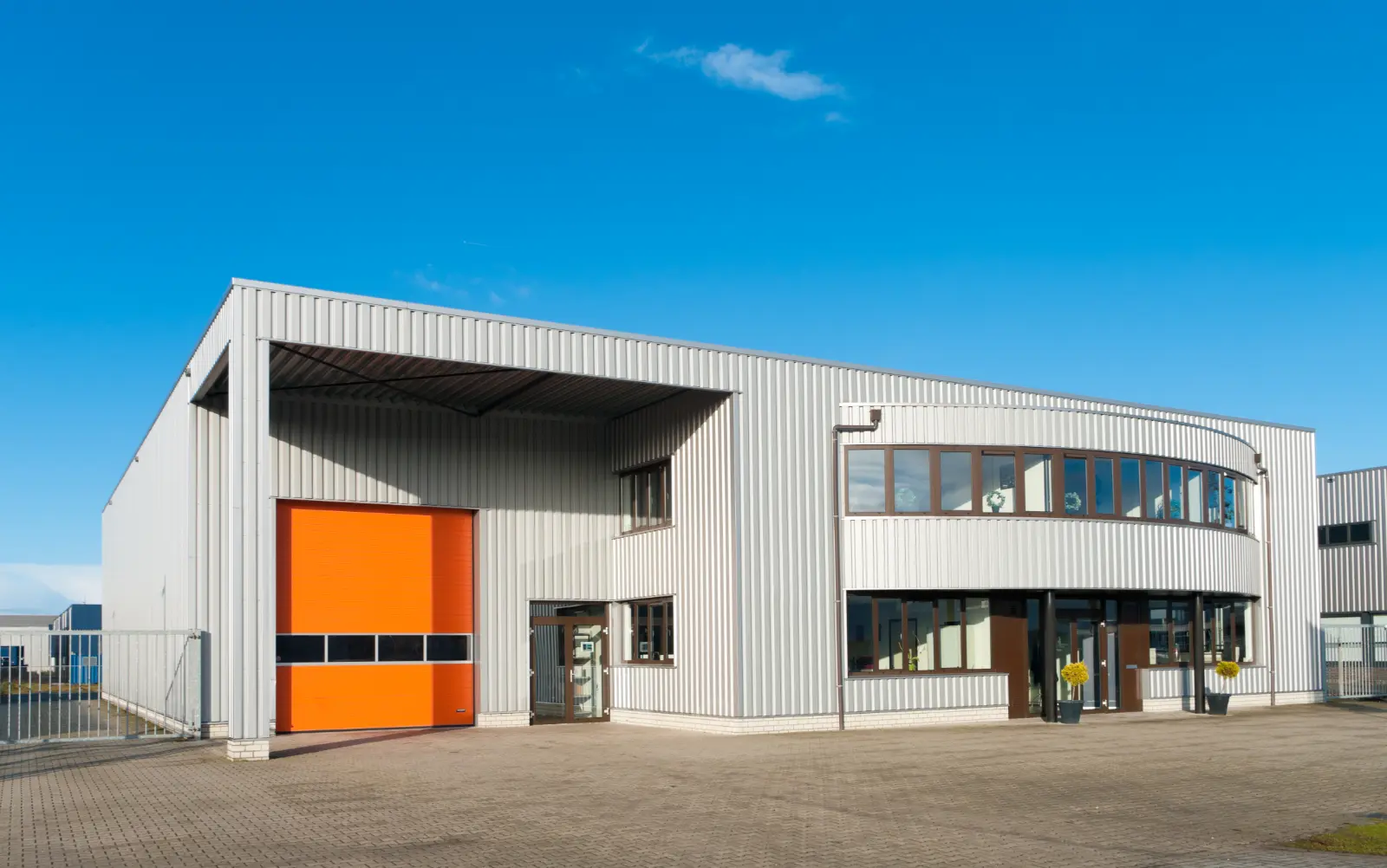 office building with orange garage Explore diverse Garage Door Models for a perfect blend of aesthetics and functionality.